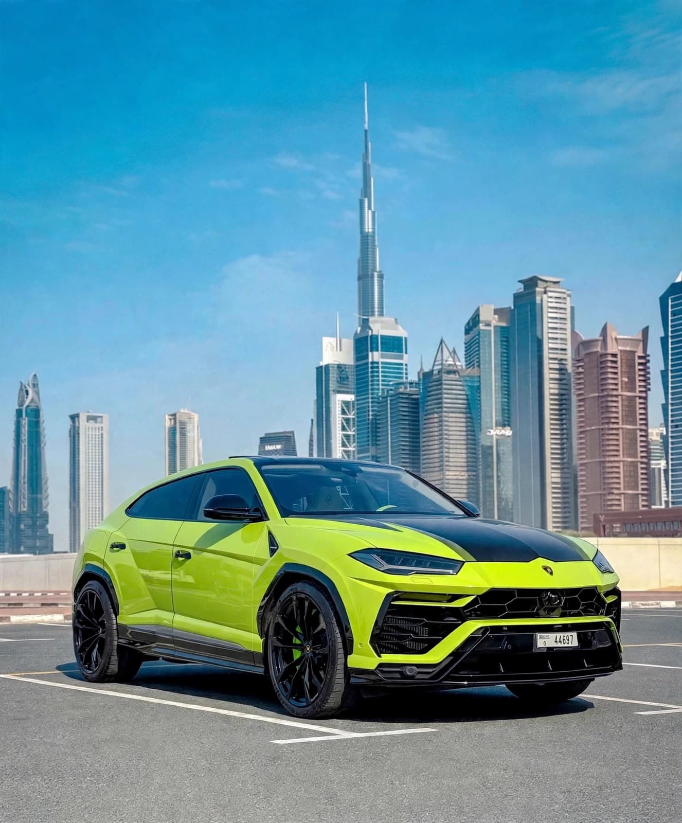 Lamborghini Urus (Green), front three-quarter view with the Burj Khalifa behind